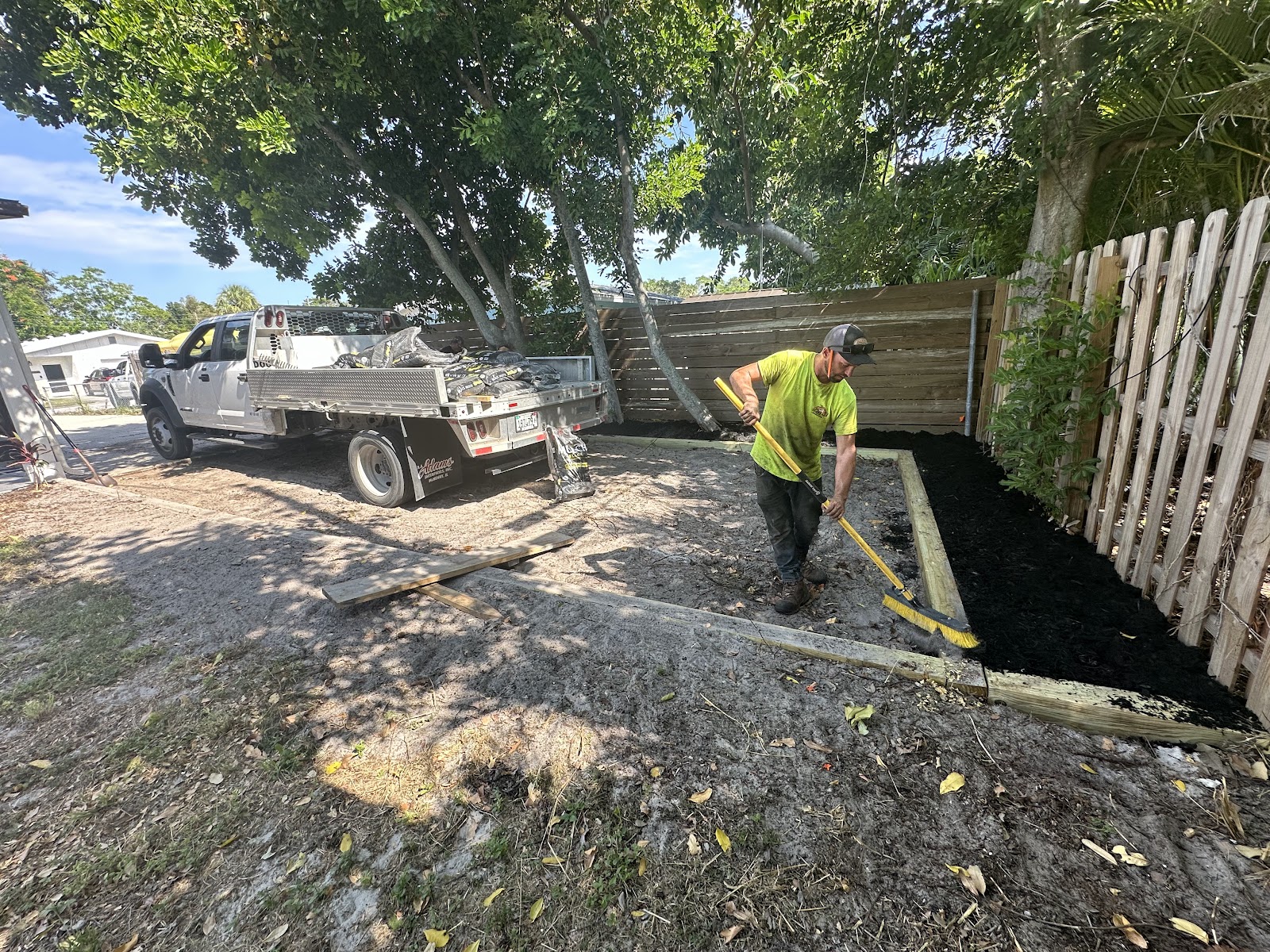 Crew spreading black mulch